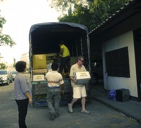 The teams starts unloading the van into the storage unit...