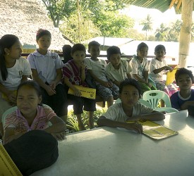 Children at Mae La receiving their first instruments and songbooks.