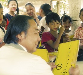 Children receive their songbooks and whistles.