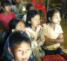 Children gather to watch a show.